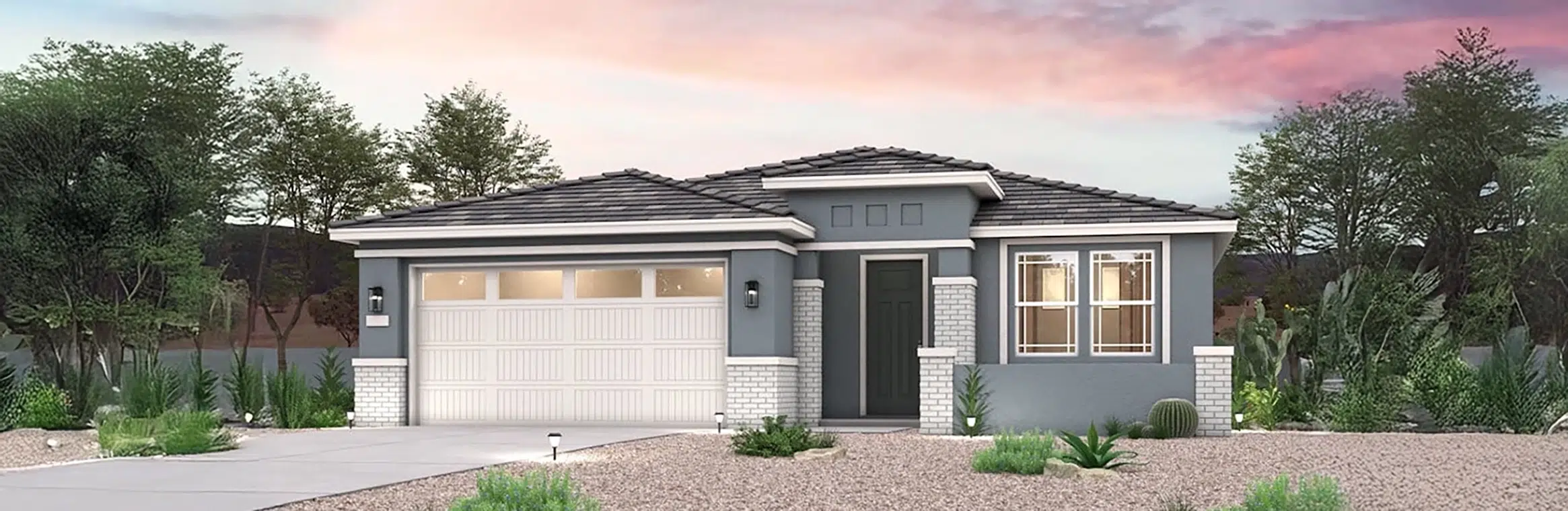 Single-story modern house with a two-car garage, grey siding, white trim, and desert landscaping under a pink and purple sunset sky.