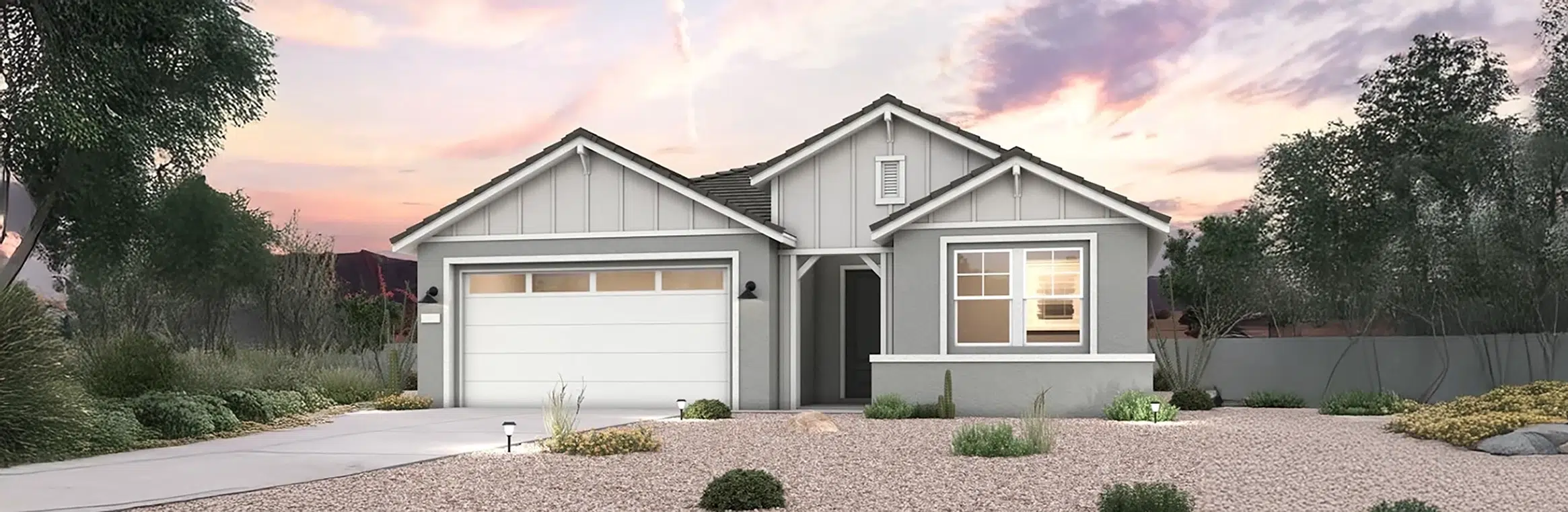 Single-story gray house with white trim, two-car garage, front yard landscaped with gravel and drought-tolerant plants, under a sunset sky.