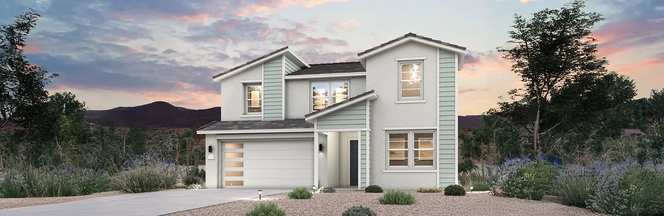 Modern two-story house with a double garage, light blue siding, and large windows, surrounded by desert landscaping at dusk.