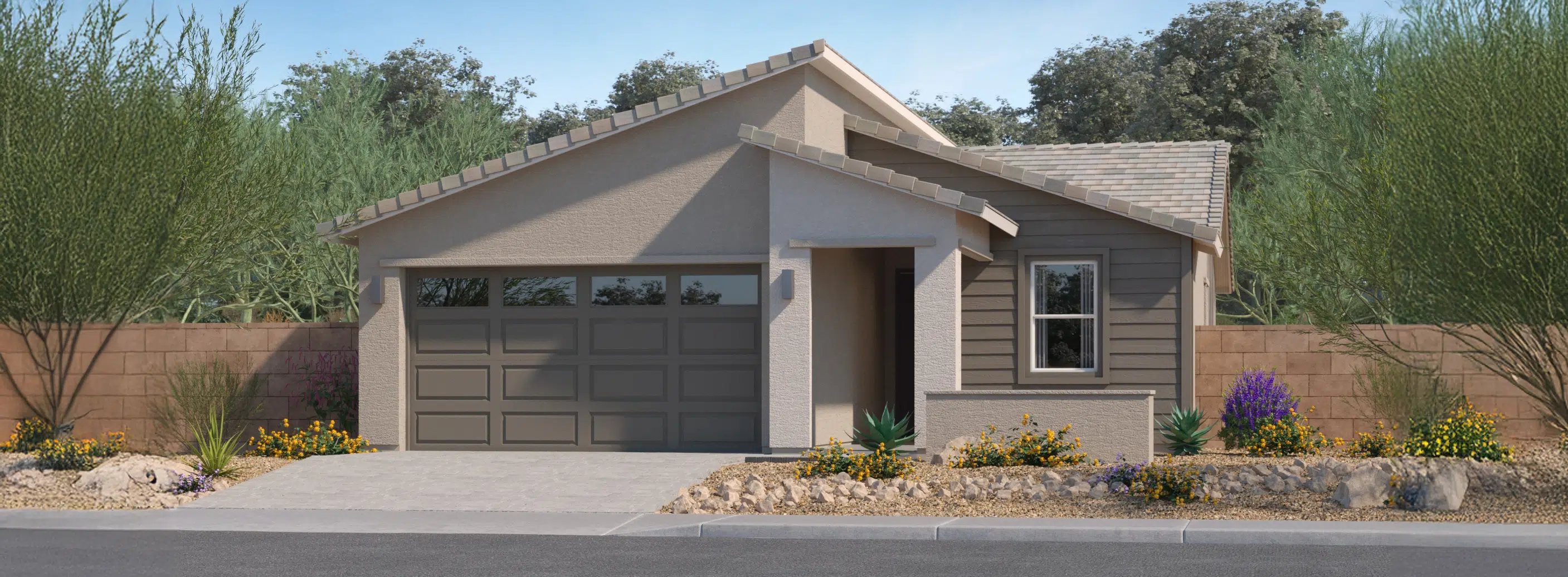 Single-story modern house with a two-car garage, desert landscaping, and a sloped roof, set against a backdrop of trees and a stone wall.
