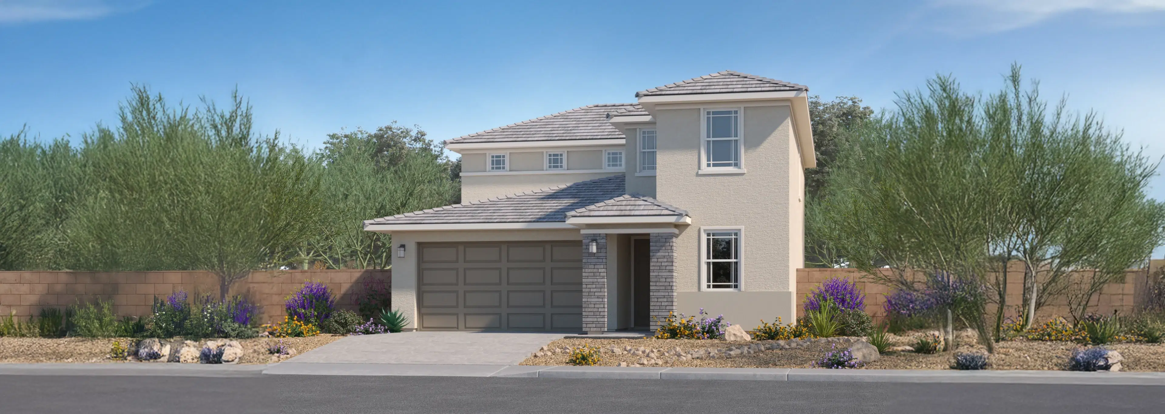 Two-story beige suburban house with a two-car garage, tile roof, and desert landscaping in front, set against a clear blue sky.