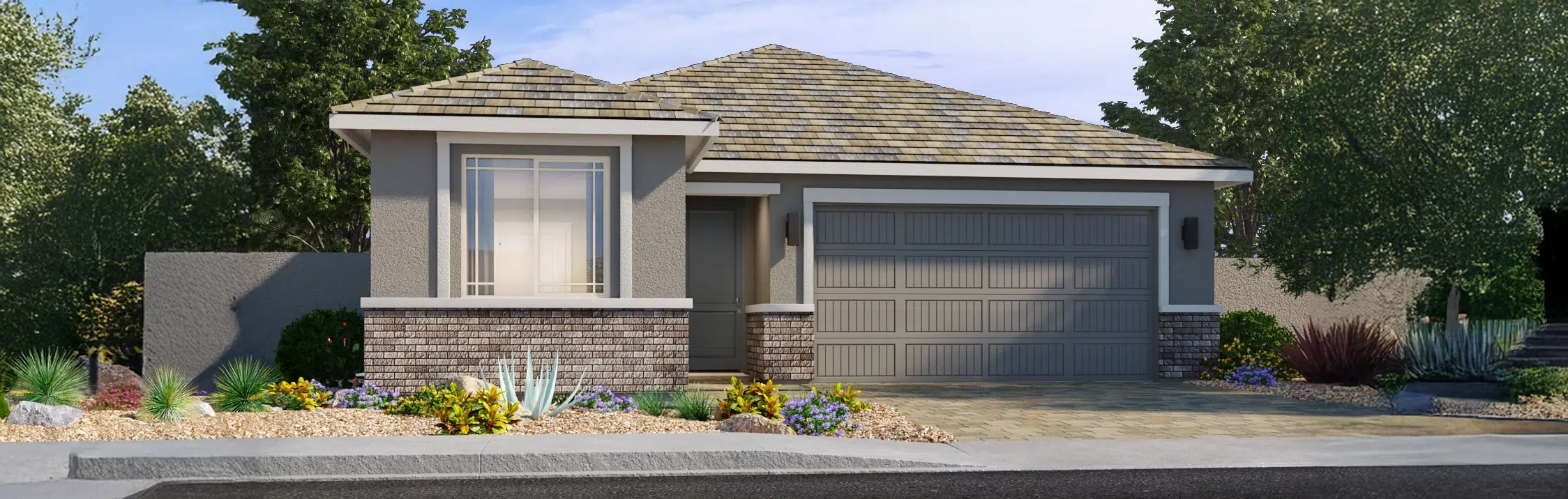 Single-story suburban house with a two-car garage, brick and stucco exterior, and desert landscaping with rocks and drought-tolerant plants.