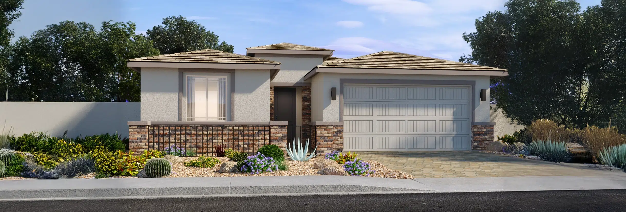 Single-story house with a two-car garage, beige walls, and brick accents, surrounded by desert landscaping with rocks and various drought-tolerant plants.