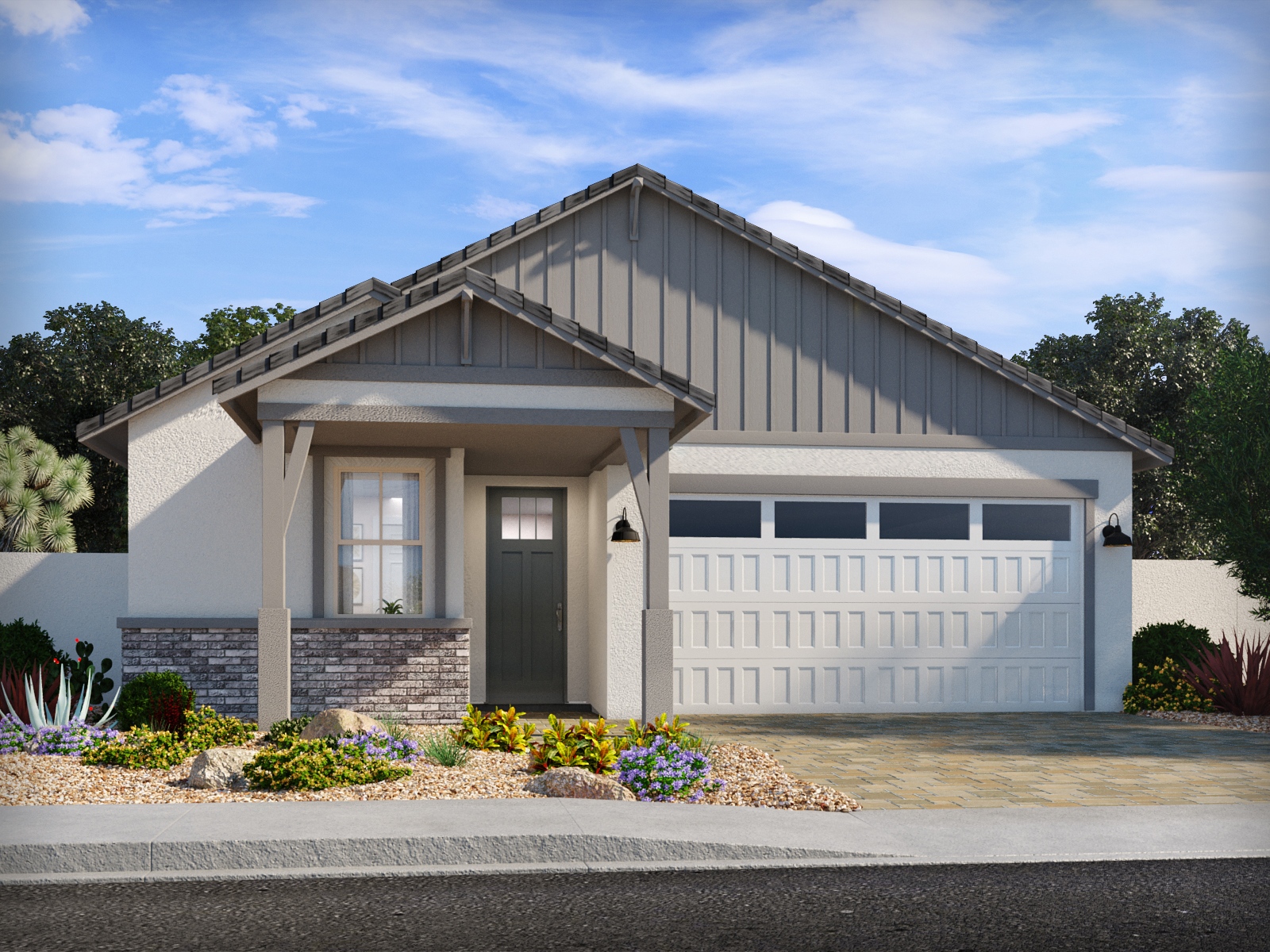 Single-story house with a gabled roof, gray siding, stone accents, a two-car garage, and a landscaped front yard with desert plants.
