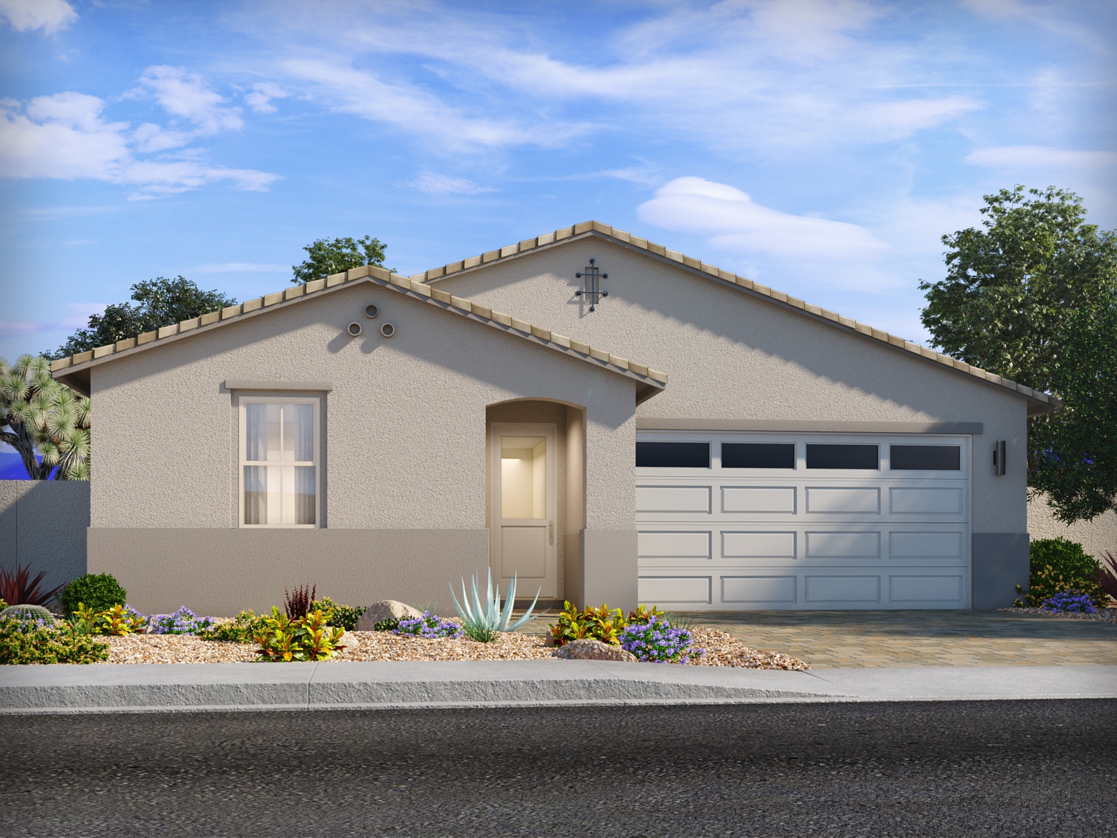 Single-story beige stucco house with a two-car garage, small front window, and desert landscape with rocks and low plants under a blue sky.