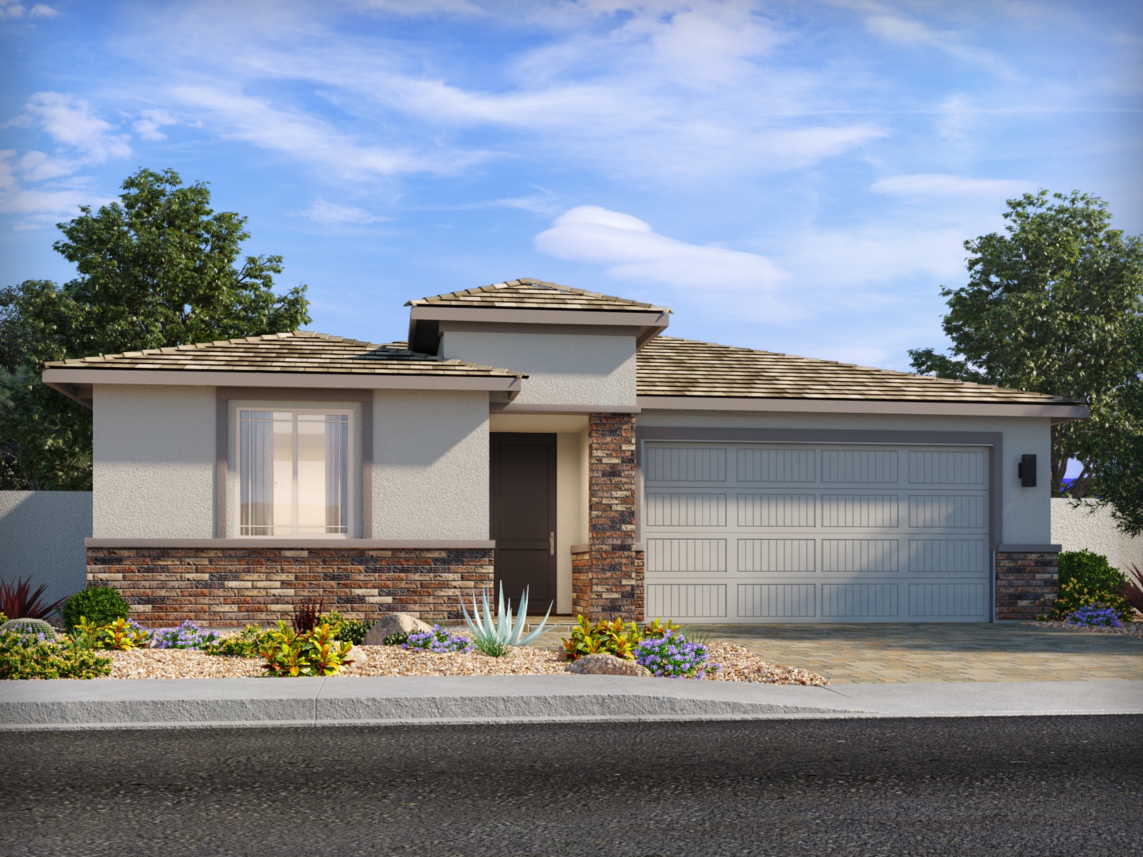 Single-story modern house with a two-car garage, stone and stucco exterior, tiled roof, and minimal desert landscaping in front.