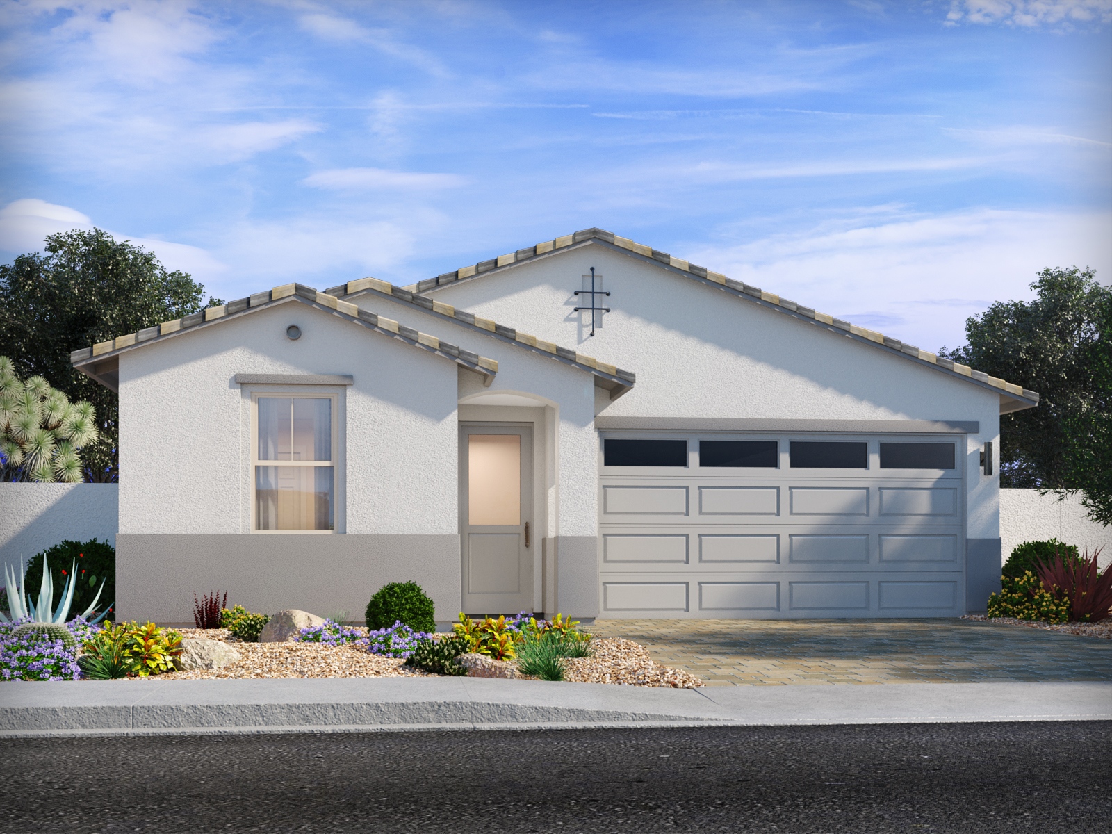 Single-story modern house with white exterior, light brown trim, two-car garage, desert landscaping, and a clear blue sky in the background.