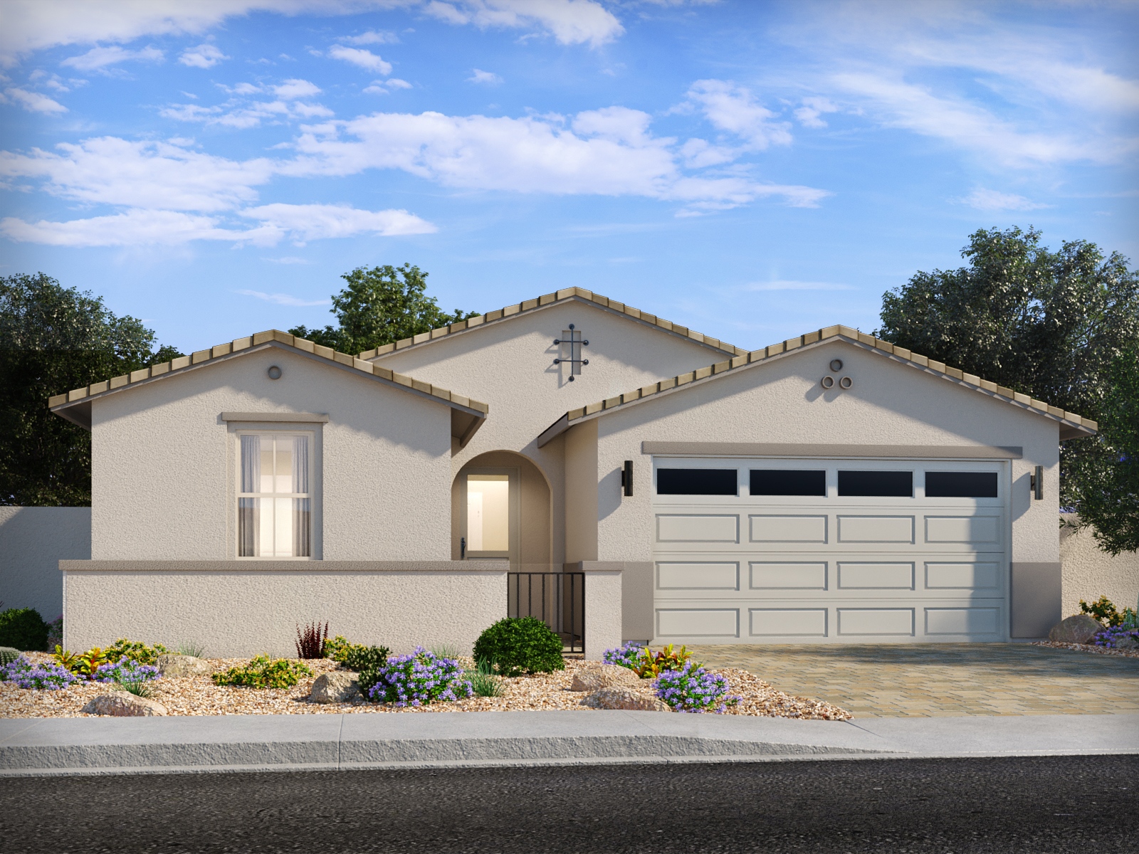 Single-story, beige stucco house with a two-car garage, small front yard with desert landscaping, and a paved driveway under a blue sky.