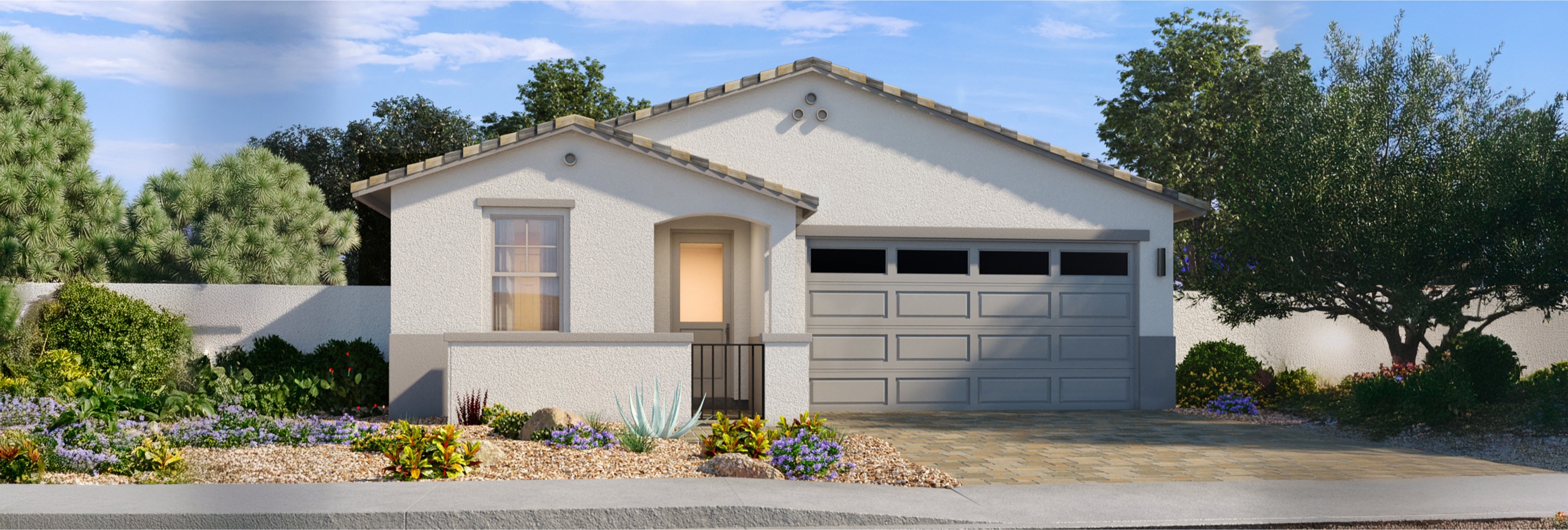 One-story house with white stucco exterior, two-car garage, tile roof, small porch, and desert landscaping in the front yard.