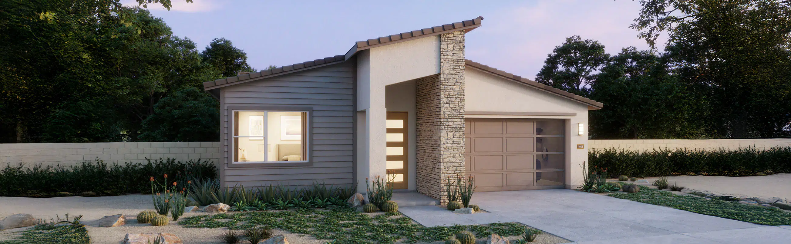Single-story modern house with a stone accent wall, attached garage, and xeriscaped front yard with desert plants and gravel.