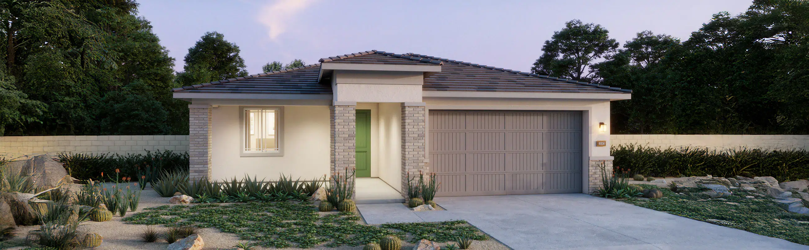 Single-story house with light-colored exterior, tile roof, double garage, and a landscaped front yard with rocks and desert plants.