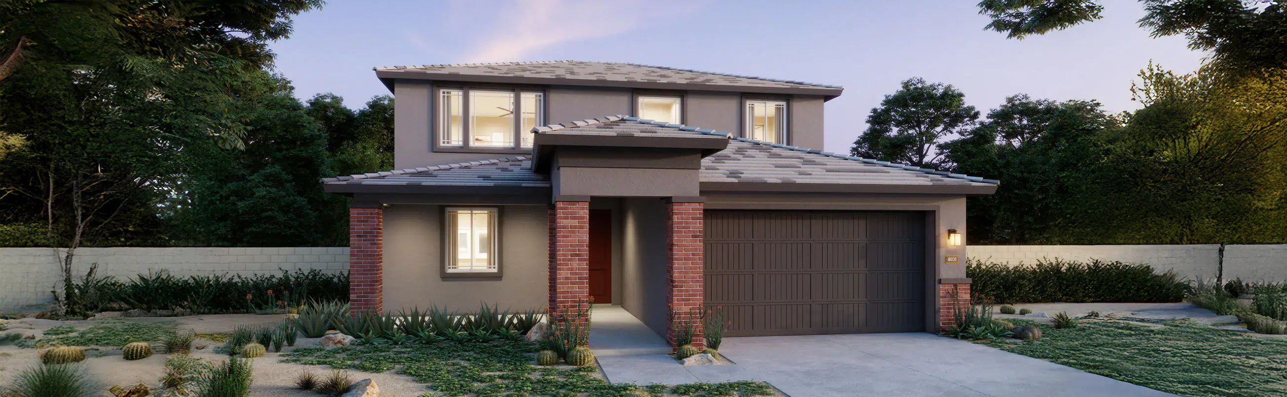 Two-story modern house with gray exterior, brick columns, a double garage, and desert landscaping in front yard at dusk.