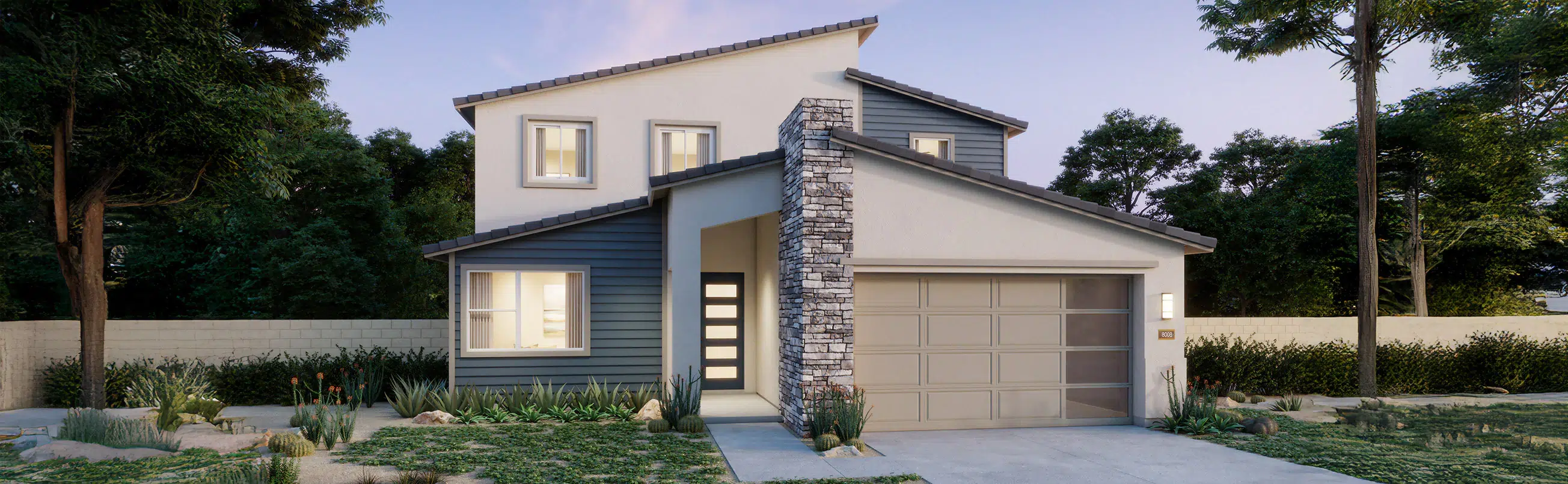 Two-story modern house with a stone accent chimney, gray siding, large windows, and an attached two-car garage, surrounded by trees and landscaping.