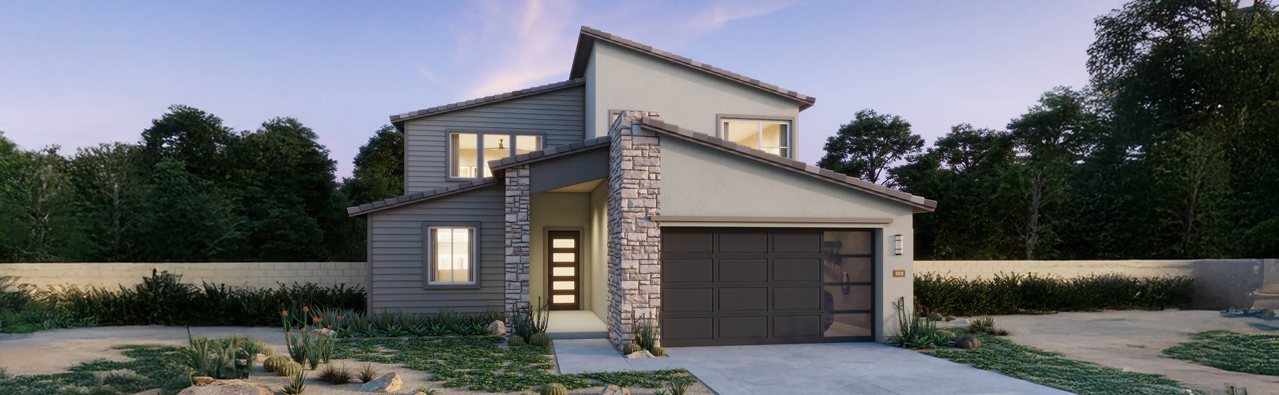 Modern two-story house with a stone-accented entrance, large windows, and a double garage, surrounded by minimal landscaping and trees in the background.