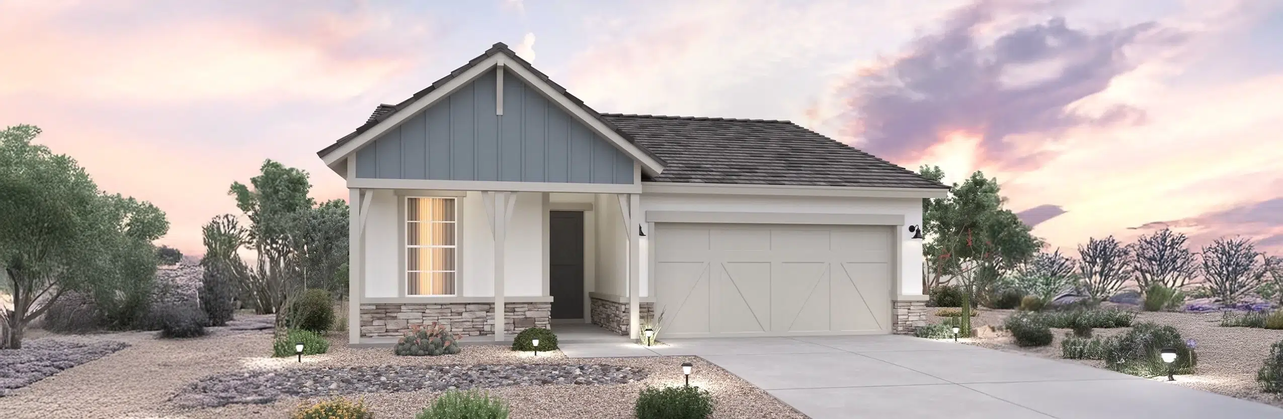 Single-story suburban house with a two-car garage, white and blue-gray siding, and a xeriscaped front yard under a partly cloudy sky at sunset.
