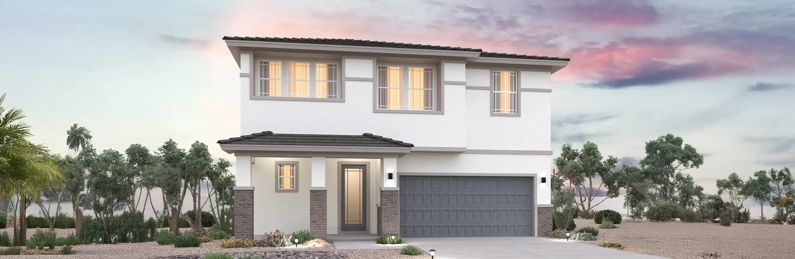 Two-story modern house with a gray tiled roof, double garage, and large windows, set in a landscaped yard with desert plants under a partly cloudy sky.