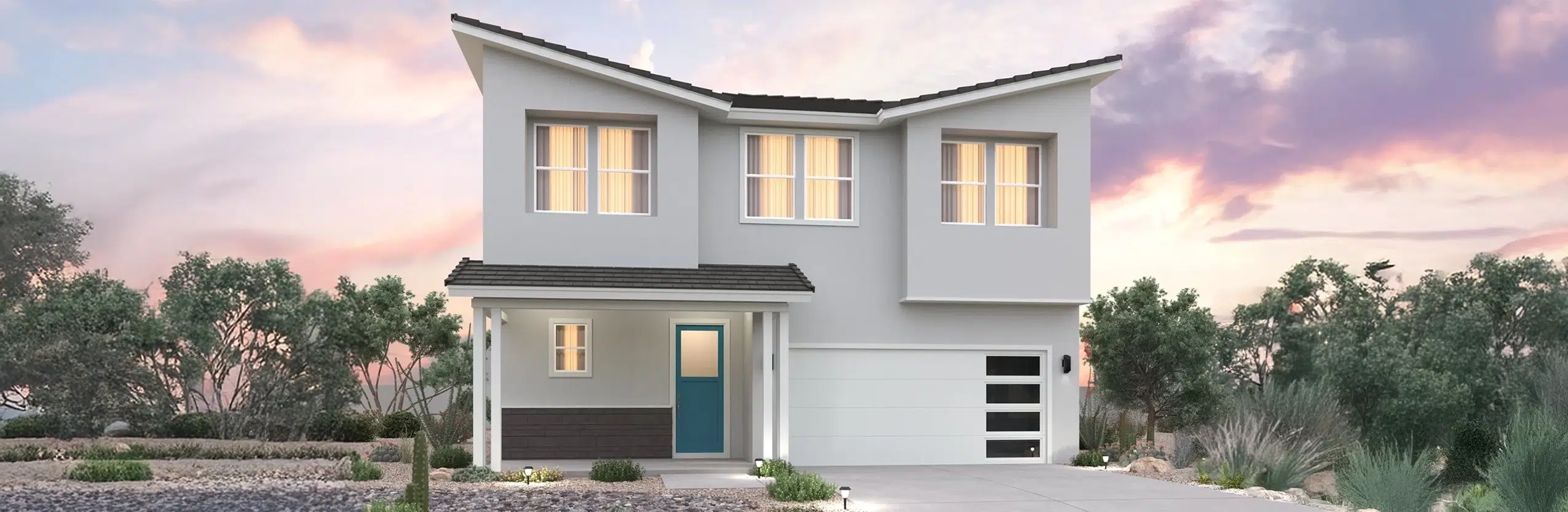 A modern two-story house with a light gray exterior, a blue front door, large windows, and a garage, surrounded by xeriscape landscaping at sunset.