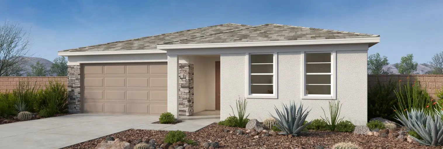 Single-story house with beige exterior, double garage, stone accents, and desert landscaping in the front yard.