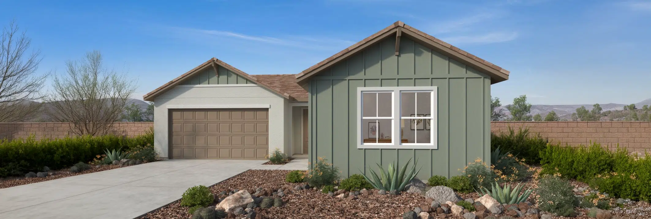 Single-story suburban house with sage green and white exterior, two-car garage, desert landscaping, and clear blue sky in the background.