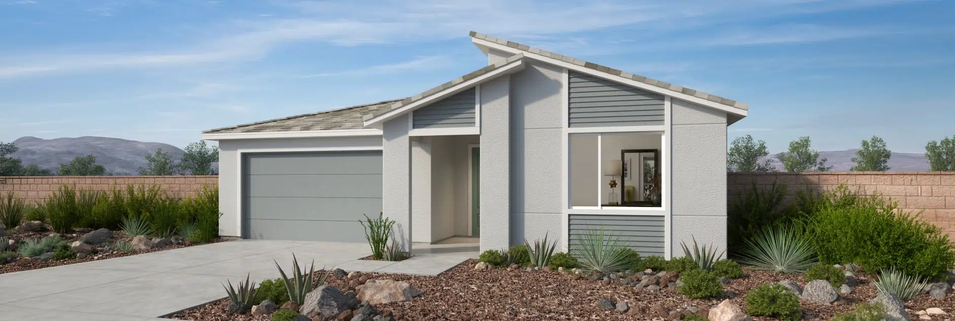 Single-story modern house with a light gray exterior, double garage, large front window, and desert landscaping in the front yard.
